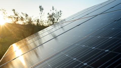 Solar panel with the sun reflecting on it Solar panel with the sun reflecting on it
