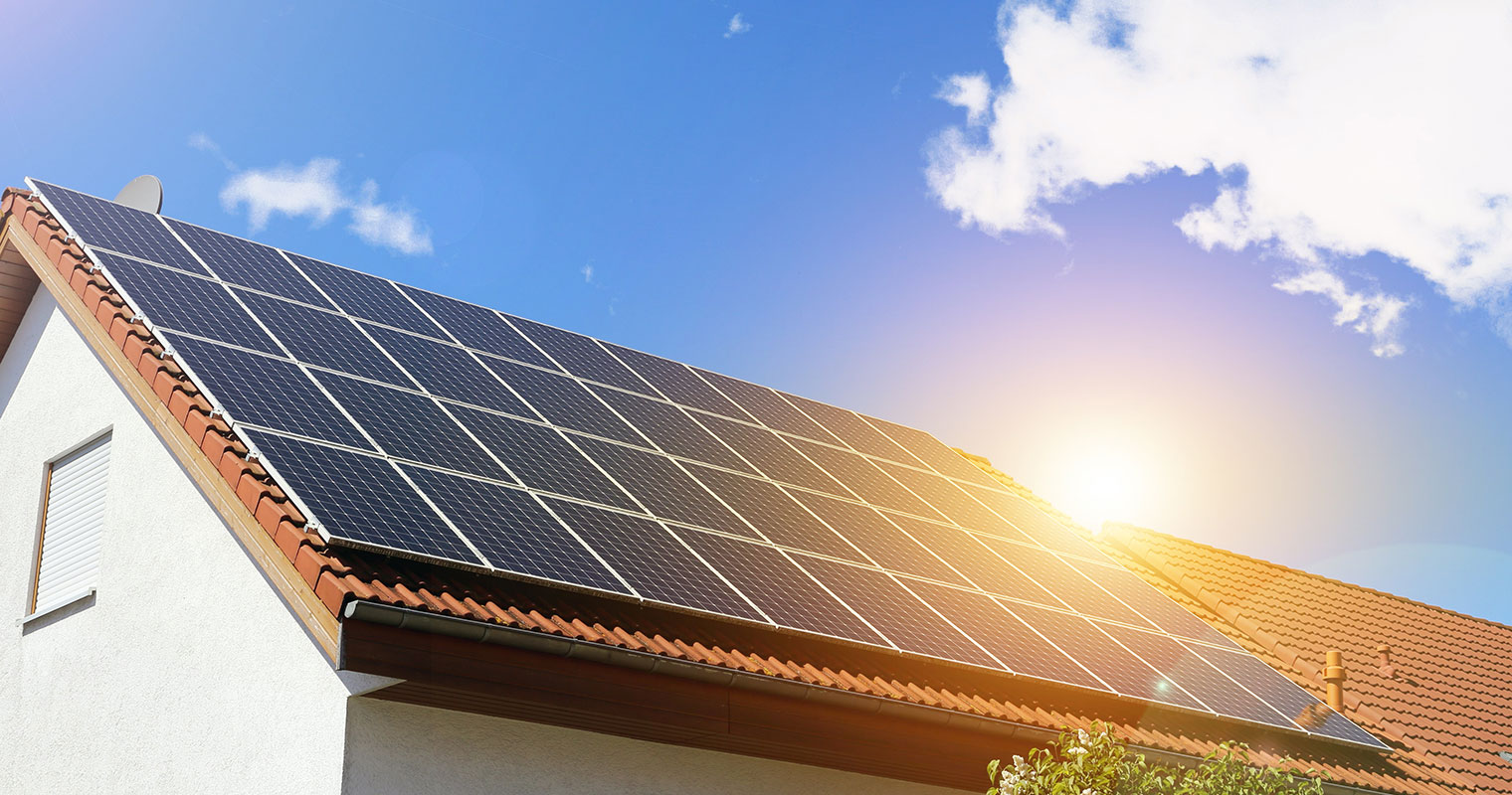 Home with solar panels on it and a blue sky